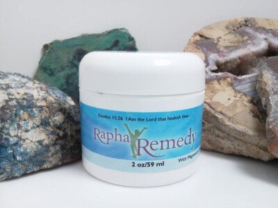 A jar of Rapha Remedy with Magnesium sitting next to some rocks.