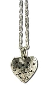 A silver Heart Pendant Diffuser on a chain.