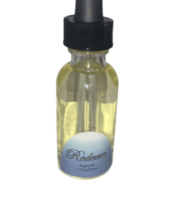 A bottle of Rapha Spa Redeem Night Oil with a black lid on a white background.