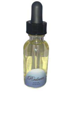 A bottle of Rapha Spa Redeem Night Oil with a black lid on a white background.