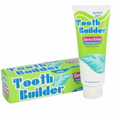 A tube of Tooth Builder (36% Xylitol) in front of a box.